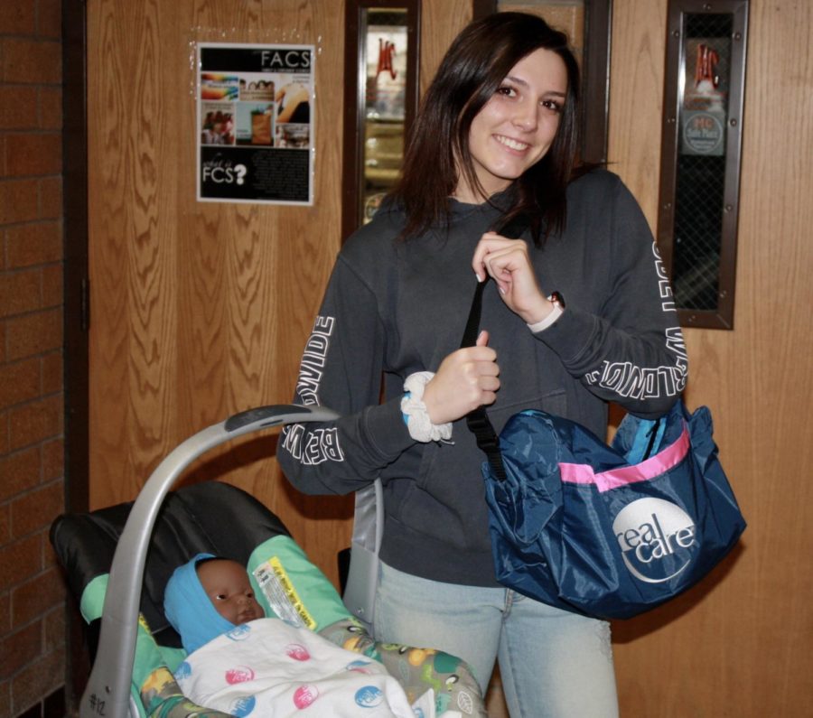 Sydney Wursten holding her baby. Photo by Saylor Funk.